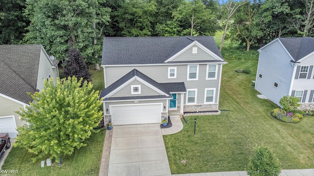 view of front of home featuring a garage, stone siding, concrete driveway, and a shingled roof