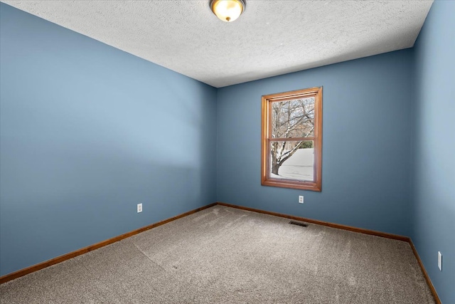 unfurnished room featuring visible vents, a textured ceiling, baseboards, and carpet flooring