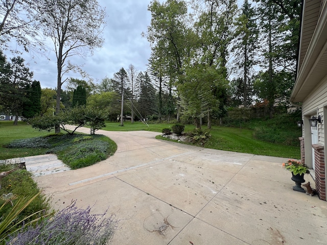 view of community featuring a yard and a patio