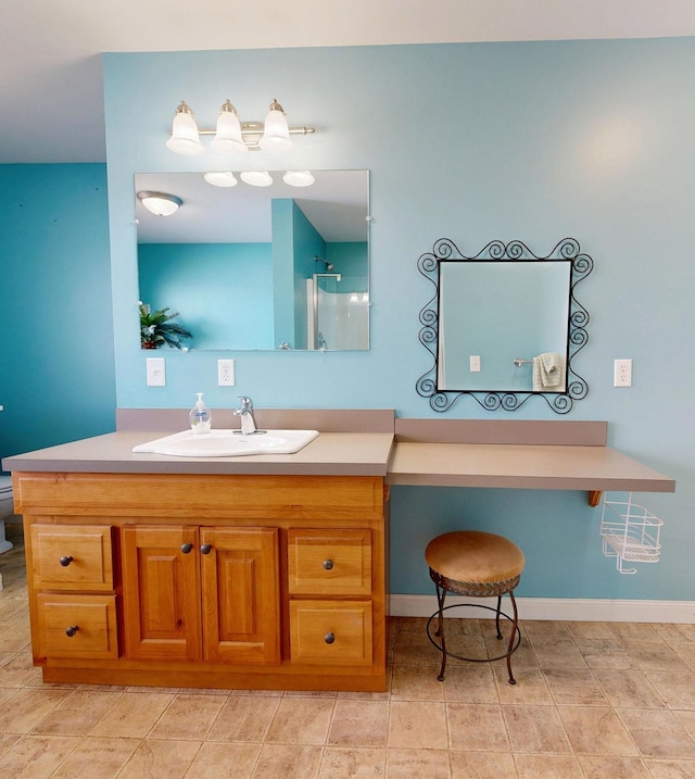 bathroom with walk in shower, baseboards, toilet, and vanity