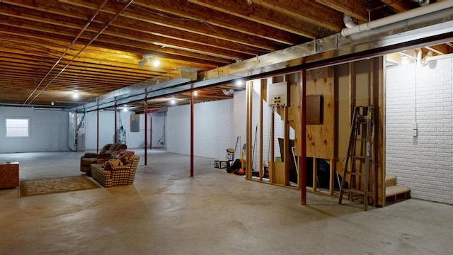 basement featuring brick wall and stairs