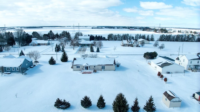 snowy aerial view with a residential view