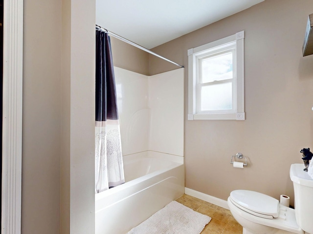 full bathroom with tile patterned floors, baseboards, shower / bath combination with curtain, and toilet