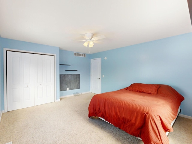 carpeted bedroom featuring a closet, a ceiling fan, baseboards, and visible vents