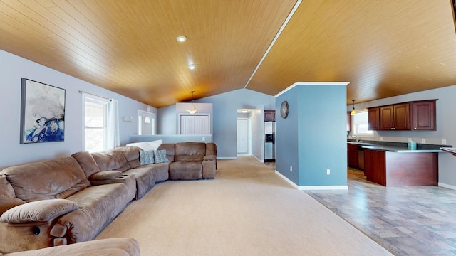 living area with wood ceiling, vaulted ceiling, and baseboards