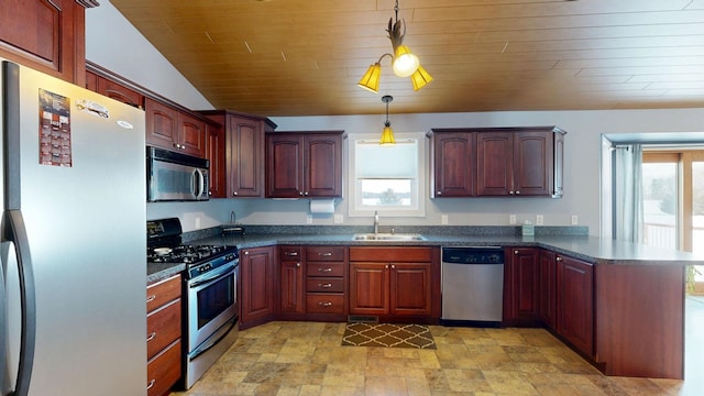 kitchen with stainless steel appliances, dark countertops, pendant lighting, and a sink