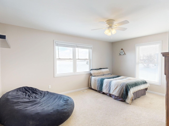 bedroom with multiple windows, baseboards, and carpet