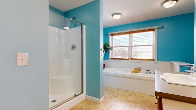 full bath with vanity, a stall shower, and a garden tub