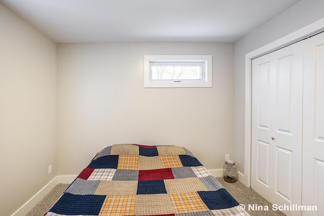 unfurnished bedroom with baseboards, a closet, and carpet