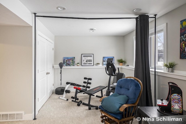 workout area with light colored carpet and visible vents