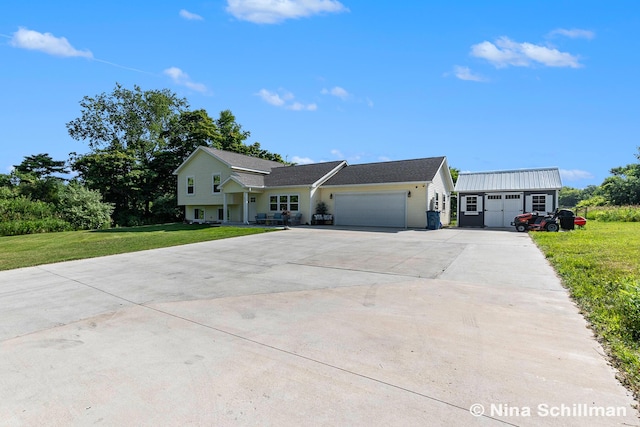 834 N Michigan St, Fremont, MI 49412 - view of front facade with a garage, driveway, and a front yard