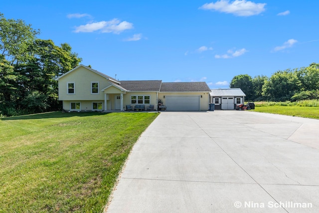 834 N Michigan St, Fremont, MI 49412 - split level home with an attached garage, driveway, and a front lawn