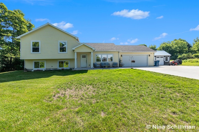 834 N Michigan St, Fremont, MI 49412 - tri-level home with concrete driveway, a garage, and a front yard