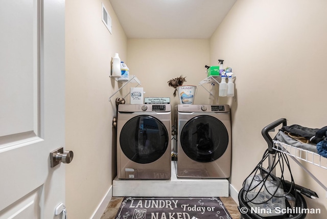 834 N Michigan St, Fremont, MI 49412 - washroom featuring washing machine and dryer and wood finished floors