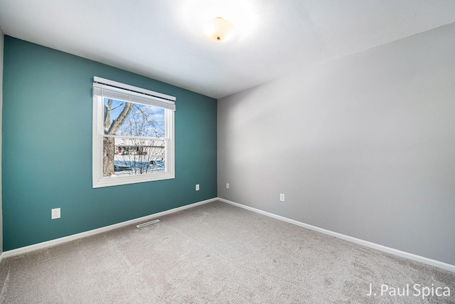 unfurnished room featuring carpet floors, baseboards, and visible vents