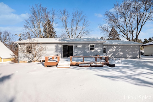 snow covered property with a wooden deck