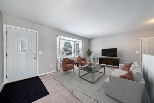 carpeted living room with visible vents and baseboards