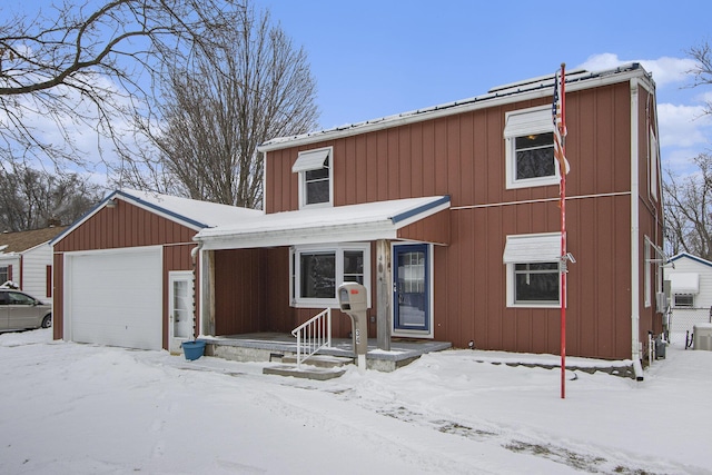 view of front of house with a garage, central air condition unit, and cooling unit