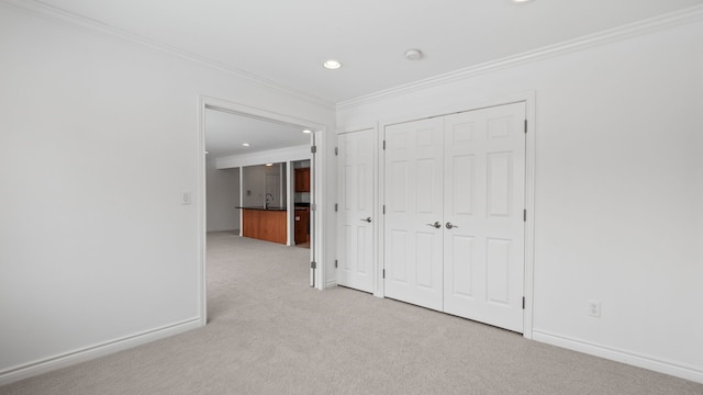 unfurnished bedroom featuring recessed lighting, baseboards, ornamental molding, and light colored carpet