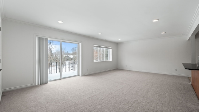 unfurnished living room featuring light carpet, baseboards, and crown molding