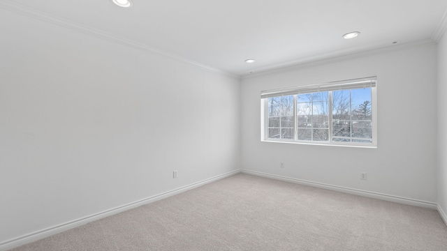 spare room with recessed lighting, baseboards, crown molding, and carpet flooring