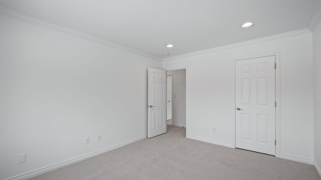 unfurnished bedroom featuring light carpet, recessed lighting, baseboards, and crown molding