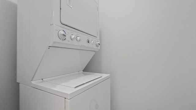 clothes washing area featuring laundry area and stacked washer / dryer