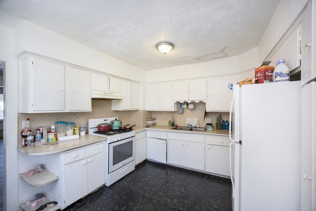 kitchen featuring white appliances, white cabinetry, and light countertops