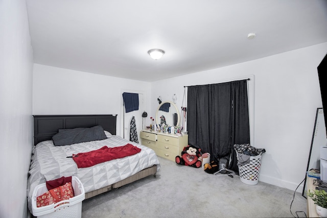 bedroom with carpet floors and baseboards