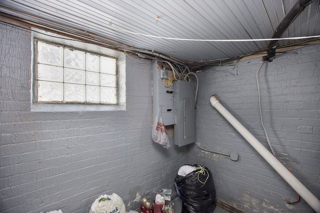 basement with brick wall and electric panel