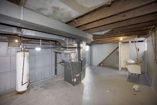 unfinished below grade area featuring heating unit and water heater