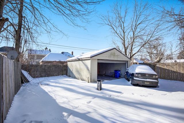 exterior space featuring a garage, fence, and an outdoor structure