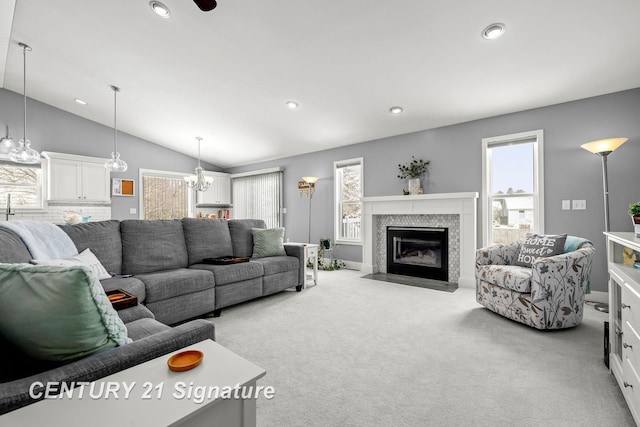 living area featuring recessed lighting, lofted ceiling, a tiled fireplace, and light carpet