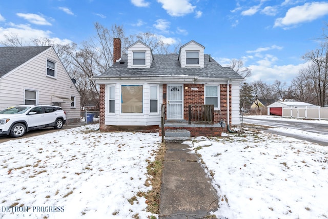 view of front of home featuring brick siding and a chimney