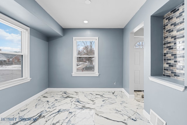 interior space with marble finish floor, visible vents, and baseboards