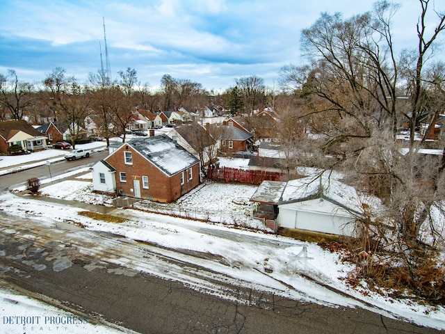 snowy aerial view with a residential view