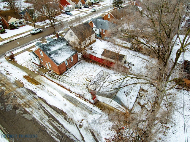 snowy aerial view with a residential view