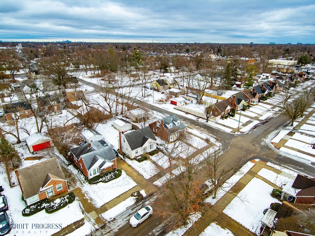 snowy aerial view with a residential view