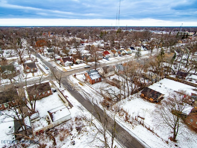 snowy aerial view with a residential view