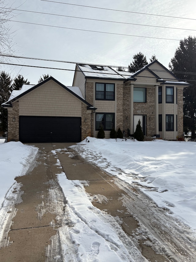 view of front of house featuring a garage and brick siding