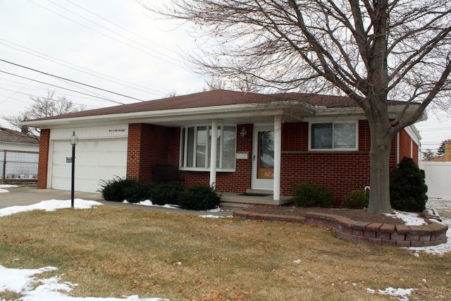 ranch-style house featuring an attached garage, a front yard, concrete driveway, and brick siding