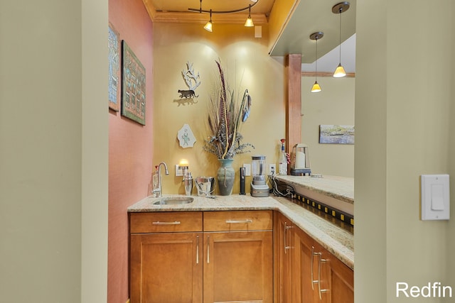 bar with a sink and hanging light fixtures