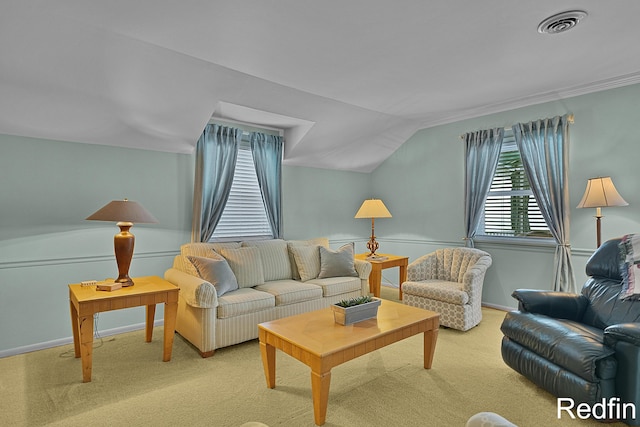 living area featuring baseboards, visible vents, lofted ceiling, and light colored carpet