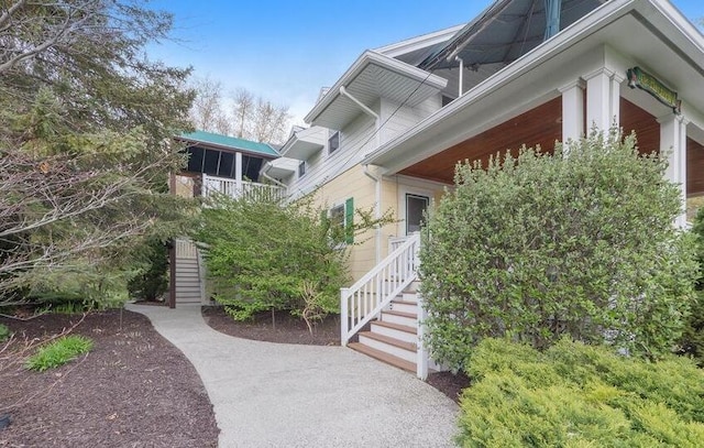 view of side of home featuring stairway