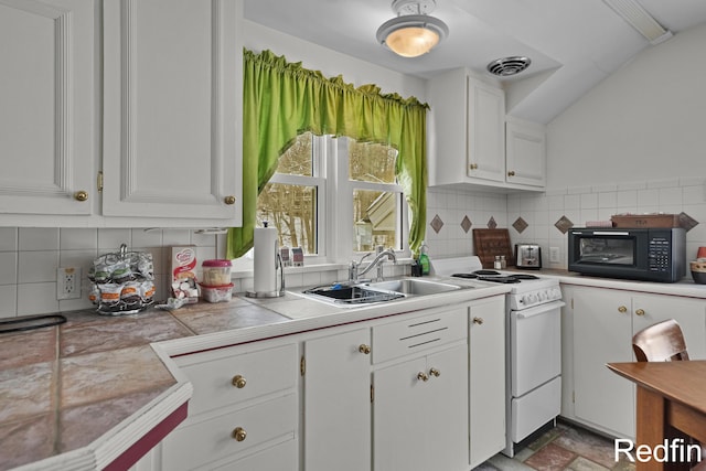 kitchen featuring a sink, electric range, white cabinets, black microwave, and tile counters