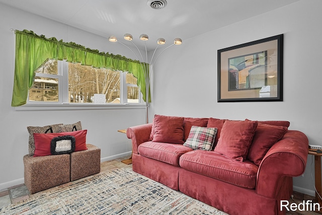 living room with baseboards and visible vents