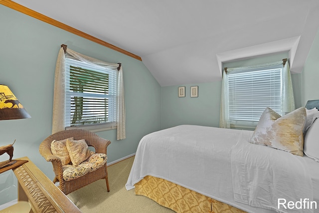 carpeted bedroom featuring baseboards and vaulted ceiling