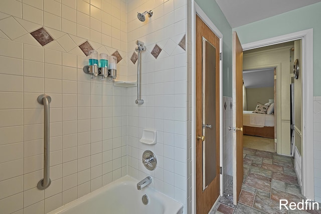 bathroom with ensuite bathroom, stone finish floor, and tub / shower combination