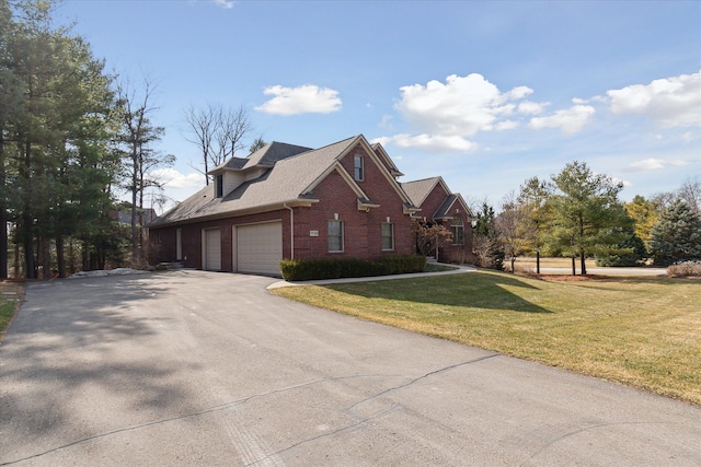 view of home's exterior with a lawn, brick siding, and driveway