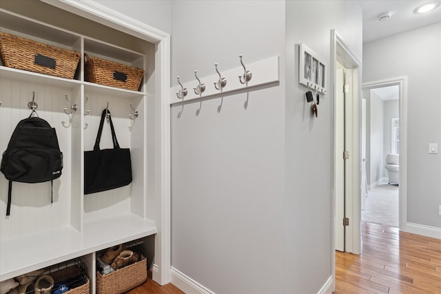 mudroom with baseboards and light wood-style floors